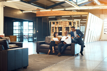 Wall Mural - Our charismatic ideas clearly set us apart from the rest. Full length shot of a group of designers having a discussion in an office.