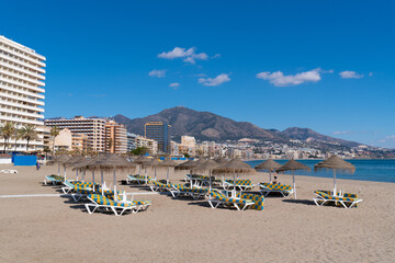 Canvas Print - Fuengirola beach Spain Playa de los Boliches with sun beds and beach umbrellas Mediterranean sea