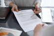 © rogerphoto - Woman accountant using a calculator and laptop computer while counting taxes for a client. Business audit and finance concepts
