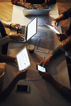 Business From Above. High Angle Shot Of A Group Of Unrecognizable Designers Having A Brainstorming Session In The Boardroom.