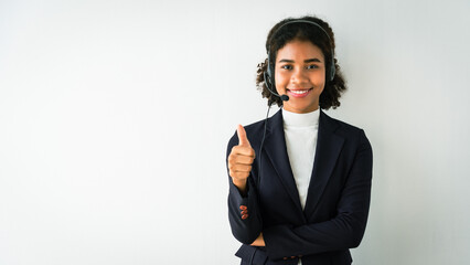 Wall Mural - African american woman wearing headset and showing thumb up while talking customer in call center