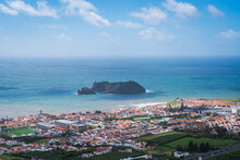 Aerial View Of The Coastline On Sao Miguel Island, With Town Buildings, Green Farmland And Volcanic Mountains, Azores, Portugal