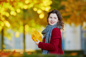 Wall Mural - Beautiful young girl in autumn park