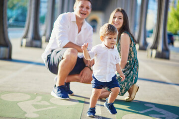 Wall Mural - Happy family of three enjoying their vacation in Paris