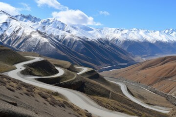 Canvas Print - view of snow-capped mountain range, with winding road through the valley, created with generative ai