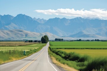 Canvas Print - scenic highway, with fields and crops in the foreground and mountains in the background, created with generative ai