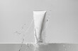 © Daryna  - White mockup tube of cream with splash of water on isolated background. The concept of cosmetology, face and body care. Image for your design.