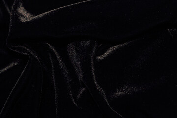 Wall Mural - Texture of black velor corduroy fabric with folds.