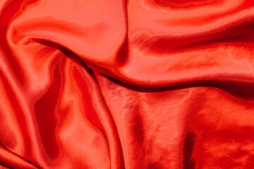 Wall Mural - Red shiny texture of silk satin satin with folds.