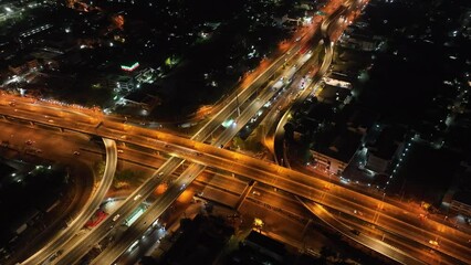Canvas Print -  Expressway top view, Road traffic an important infrastructure, car traffic transportation above intersection road in city night of advanced innovation, financial technology