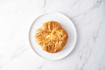 Wall Mural - Vanilla cream almonds sweet bun in a plate