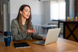 © Dorde - Confident young businesswoman employee, HR manager having remote online work hybrid meeting or distance job interview, gesturing with hands during virtual video conference call in home office.