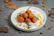 Potato croquettes - mashed potatoes balls breaded and deep fried, served with different sauce.