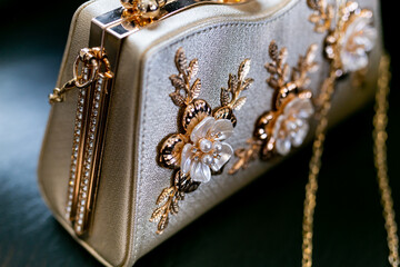 Indian bride's wedding clutch decorated with flowers close up