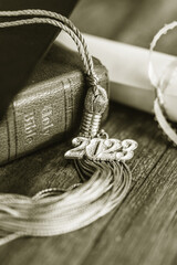 Wall Mural - a 2023 graduation tassel on a bible with a cap