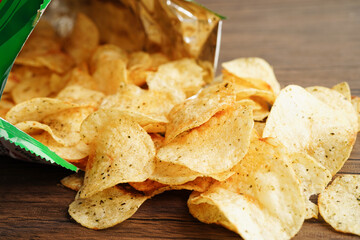 Potato chips in open bag, delicious BBQ seasoning spicy for crips, thin slice deep fried snack fast food in open bag.