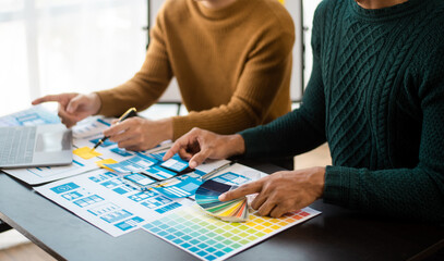 UI designer UX developer andbrainstorming about mobile app interface wireframe design with customer breif and color code.