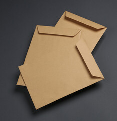 Craft postal envelopes on dark gray background