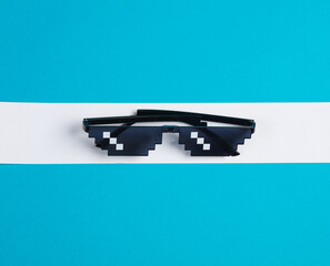 Poster - Pixel sunglasses on a blue background with a white stripe. Creative layout, minimalism, weight loss