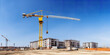 © Ployker - construction site and yellow crane on the background blue sky, panoramic mock-up - Generative AI