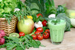 Homemade green smoothie and ingredients, green smoothie with fresh vegetables and fruits on the wooden table