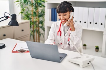 Sticker - Young woman wearing doctor uniform talking on the telephone at clinic