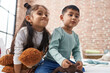 © Krakenimages.com - Adorable boy and girl smiling confident holding teddy bear at bedroom