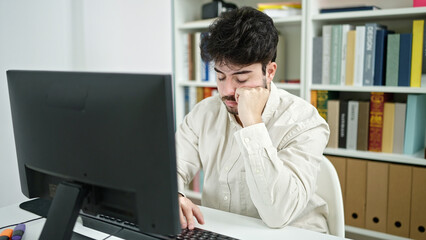 Poster - Young hispanic man student tired using computer studying at library university