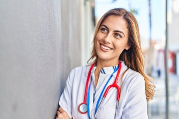 Sticker - Young blonde woman wearing doctor uniform standing at hospital