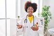 © Krakenimages.com - African american woman wearing doctor uniform speaking at clinic