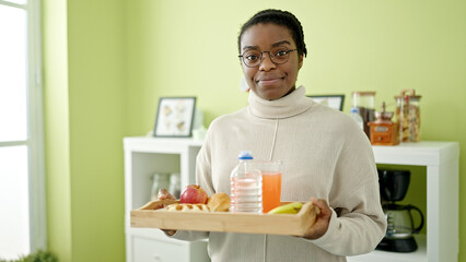 Canvas Print - African american woman smiling confident holding breakfast tray at dinning room