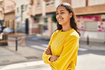 Canvas Print - Young african american woman smiling confident standing with arms crossed gesture at street