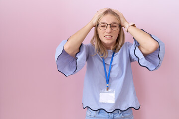 Sticker - Young caucasian business woman wearing id card suffering from headache desperate and stressed because pain and migraine. hands on head.