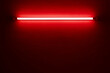 red neon light bulb on white wall..