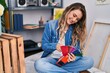 © Krakenimages.com - Young woman artist smiling confident choosing color at art studio