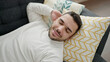 © Krakenimages.com - Young hispanic man lying on sofa sleeping at home
