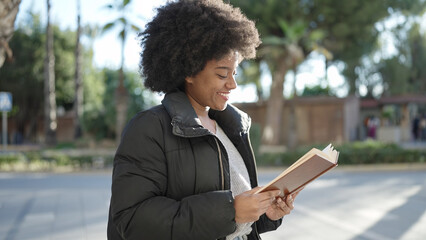 Sticker - African american woman smiling confident reading book at street