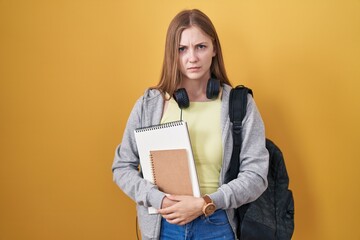 Canvas Print - Young caucasian woman wearing student backpack and holding books skeptic and nervous, frowning upset because of problem. negative person.