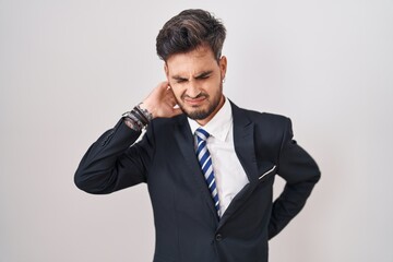 Sticker - Young hispanic man with tattoos wearing business suit and tie suffering of neck ache injury, touching neck with hand, muscular pain