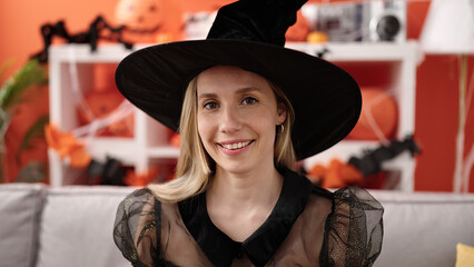 Sticker - Young blonde woman wearing witch costume having halloween party at home