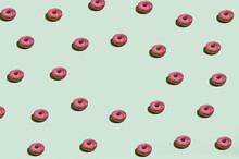 A Cheerful And Fun Pattern On A Mint Green Background Of Pink Donuts Arranged In A Circle With Space For Text In The Middle