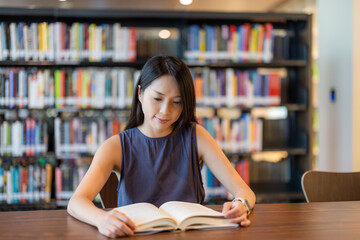 Woman read the book in library