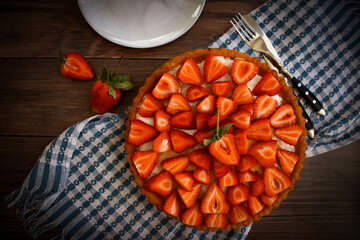 Wall Mural - Pie with fresh strawberries on old background