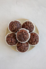 Wall Mural - Homemade Dark Chocolate Muffins on a Plate, top view. Overhead, from above, flat lay.