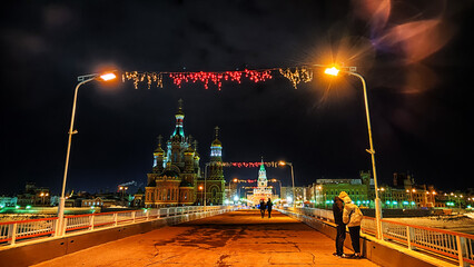 A bridge with a road and a sidewalk illuminated late at night. City bridge. Bruges Embankment in Yoshkar-Ola in Russia