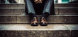 Tired or stressed businessman sitting on the walkway in the city after his work. Image of Stressed businessman concept.
