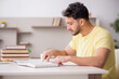© Elnur - Young male student studying at home