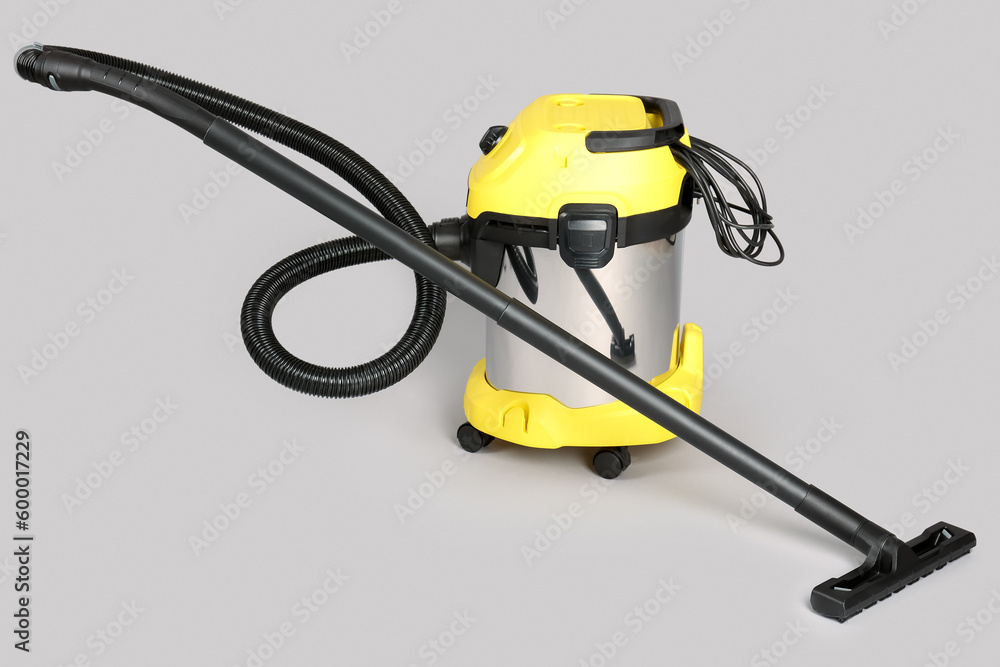 Vacuum cleaner on grey background