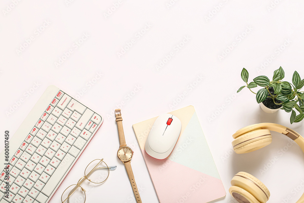 Composition with keyboard, wristwatch, mouse and headphones on white background