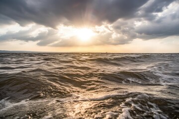 Canvas Print - beautiful sunrise over the ocean with rays of sun shining through the clouds Generative AI